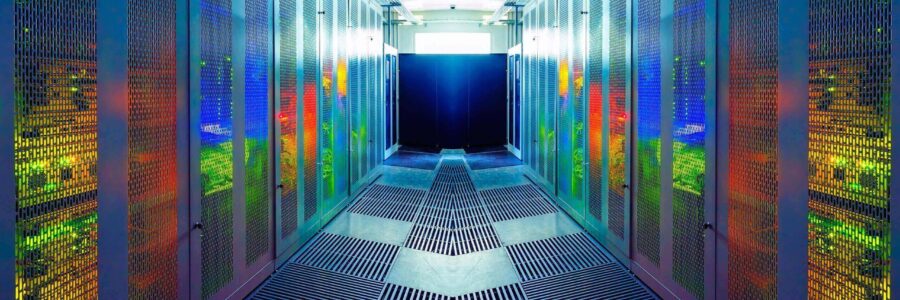 A brightly lit, futuristic data center with rows of server racks reflecting colorful lights-business continuity plan