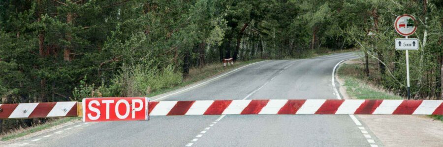 Roadblock with a red and white barrier featuring a 'STOP' sign-Web filter