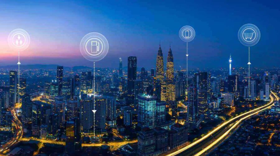 Smart city at night with interconnected digital icons-what is iot​