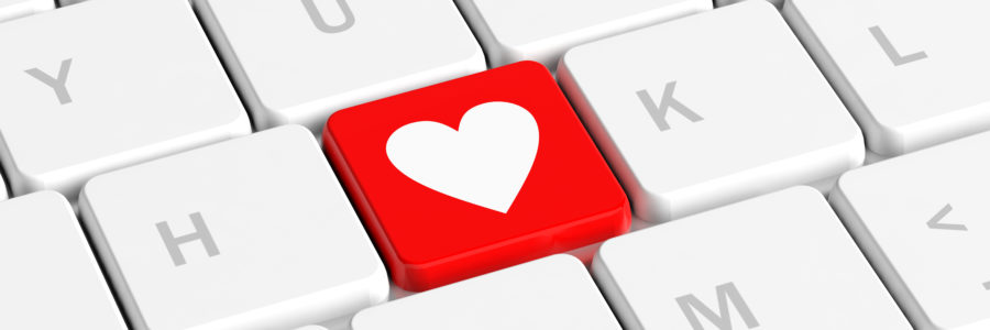 Close-up of a computer keyboard with a red key featuring a white heart symbol-computer cleaning solution