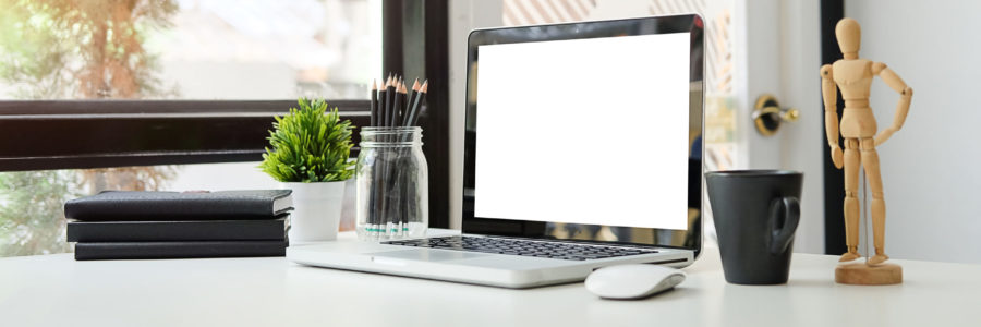 Minimalist workspace with a laptop, books, and a coffee cup on a white desk-device cleanup