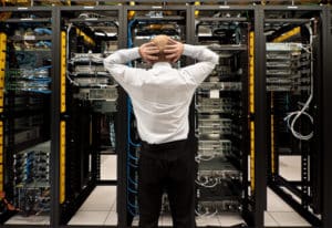 Frustrated man in midst of server and disaster recovery